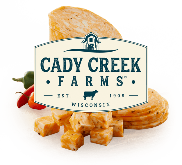 Cady Creek Farms cheese and fresh vegetables displayed on a wooden platter.